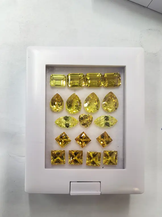 Gemformia yellow gemstone samples in step-cut, pear and other outlines